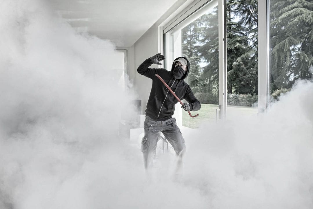 Intruder in foggy room near window.
